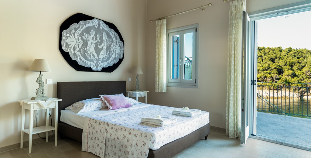 Master bedroom with double bed at Villa Plori, Assos, Kefalonia