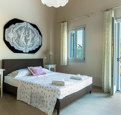 Master bedroom with double bed at Villa Plori, Assos, Kefalonia
