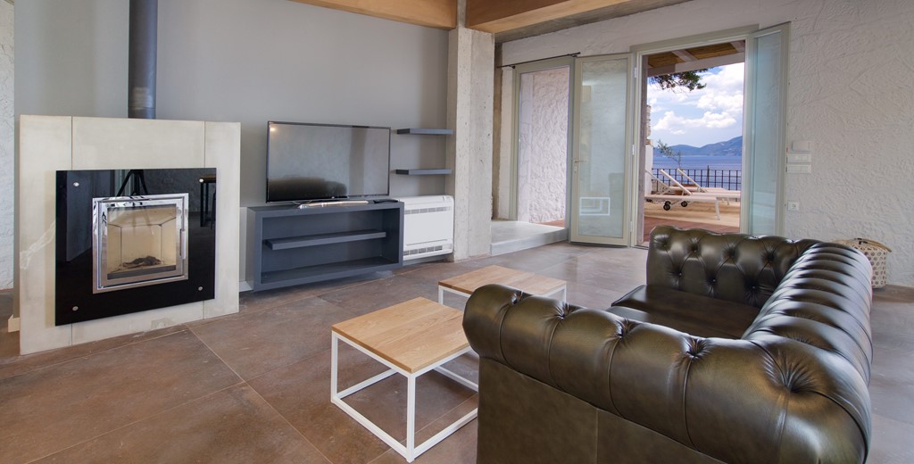 Lounge space with TV and fire inside Villa Vivere, Assos, Kefalonia