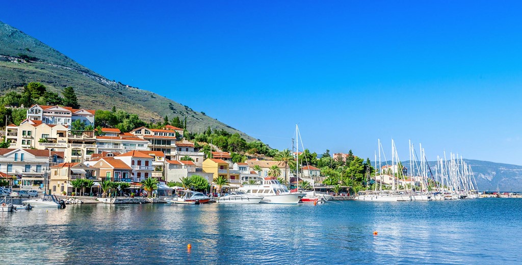 Agia Efimia waterfront with moored yachts and mountains in the distance, Kefalonia, Greek Islands