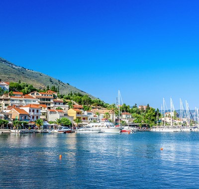 Agia Efimia waterfront with moored yachts and mountains in the distance, Kefalonia, Greek Islands