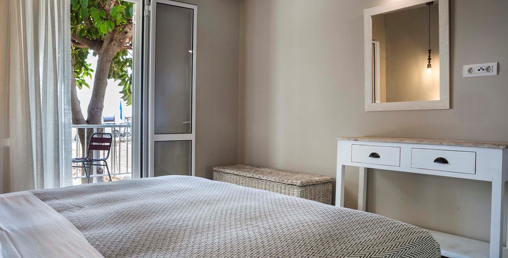 Bedroom with outside seating and air conditioning Beachfront Suite No1, Lourdata, Kefalonia