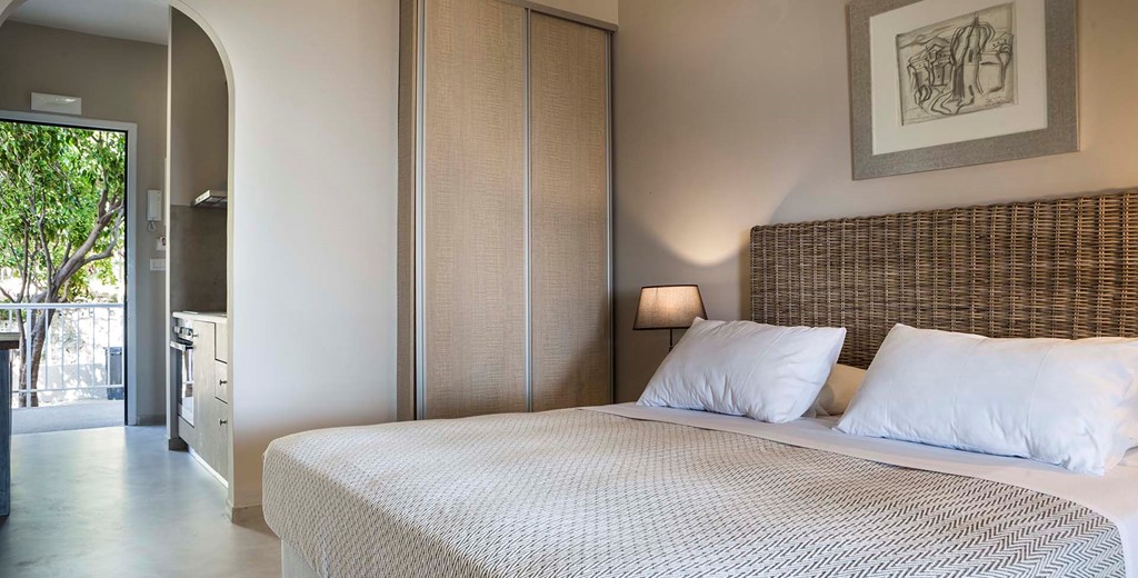 Bedroom and separated kitchen living space inside Beachfront Suite No1, Lourdata, Kefalonia