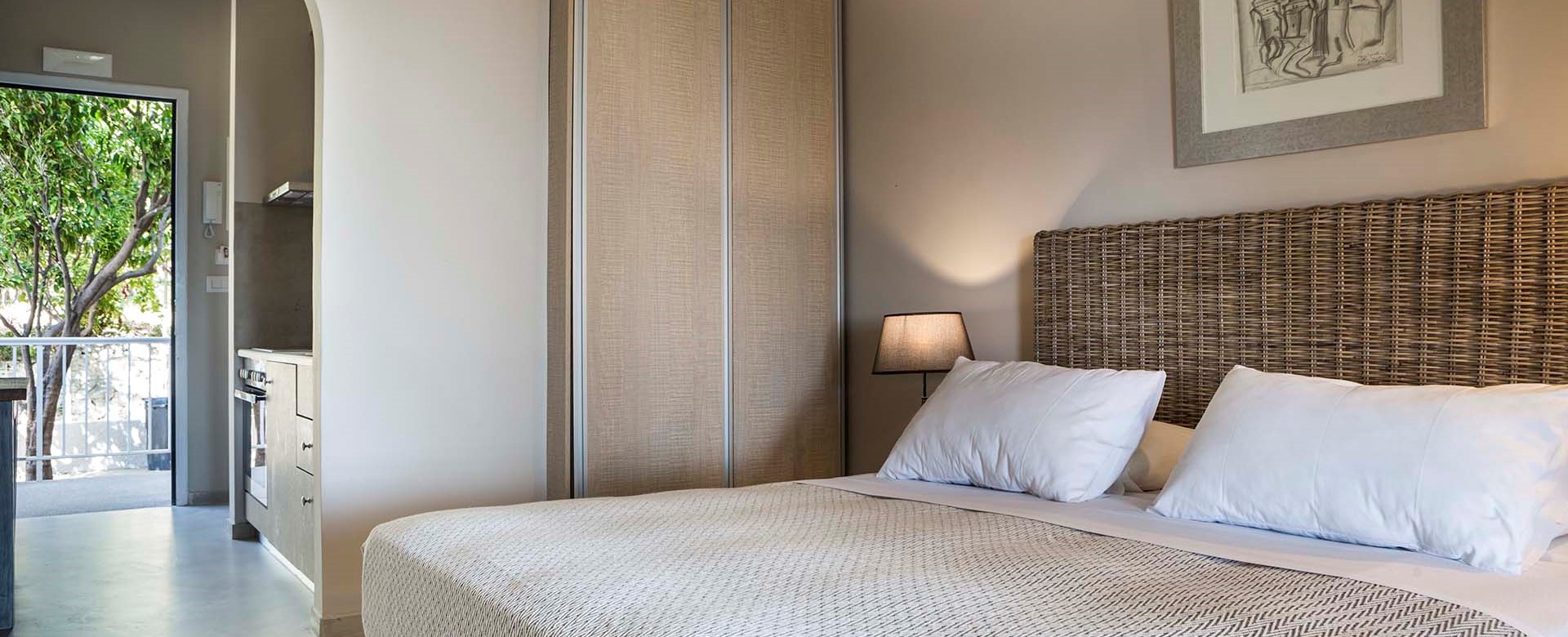 Bedroom and separated kitchen living space inside Beachfront Suite No1, Lourdata, Kefalonia