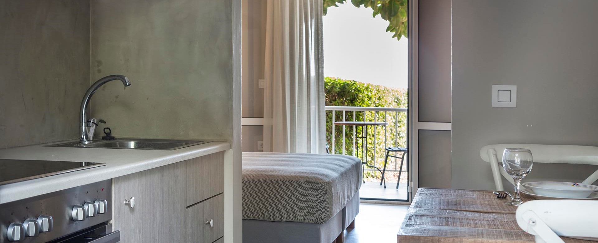 Kitchen, dining and views toward the sea through the French doors inside Beachfront Suite No1, Lourdata, Kefalonia