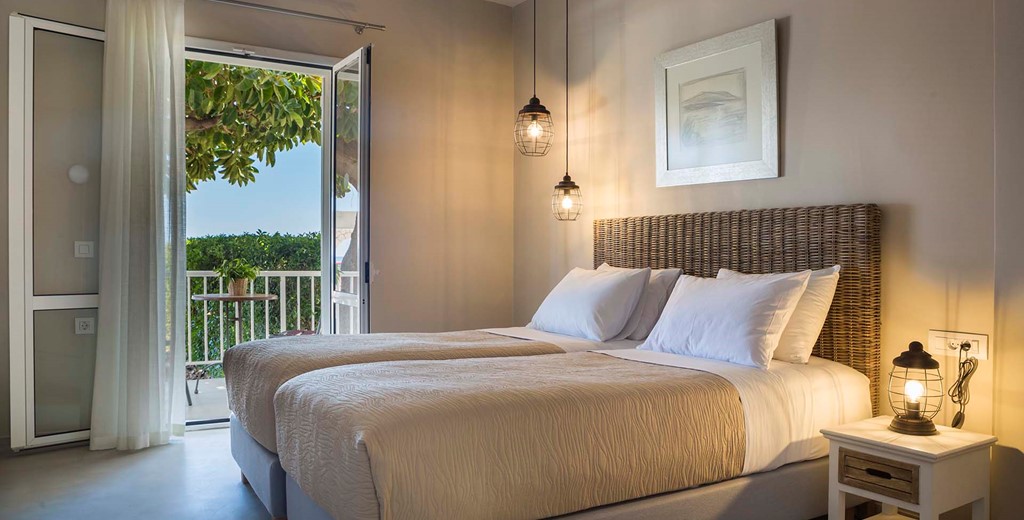 Bedroom and French doors opening onto sea views inside Beachfront Suite No2, Lourdata, Kefalonia