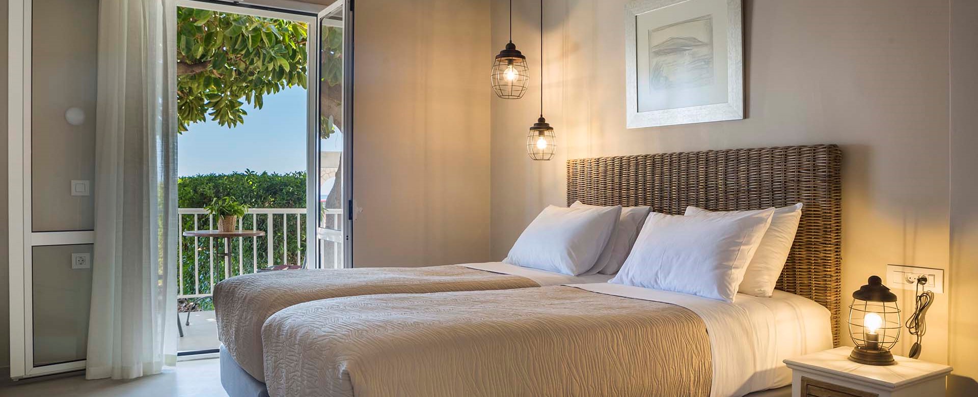 Bedroom and French doors opening onto sea views inside Beachfront Suite No2, Lourdata, Kefalonia