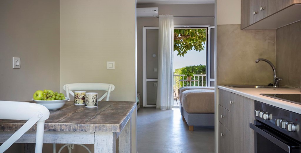 Kitchen, dining and views toward the sea through the French doors inside Beachfront Suite No2, Lourdata, Kefalonia