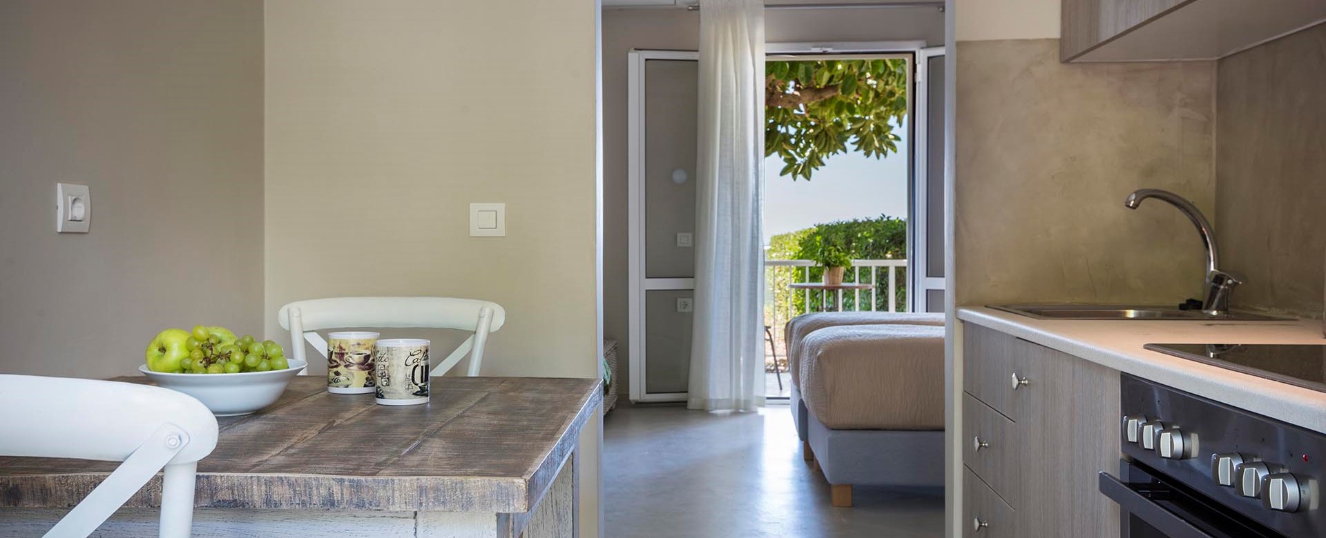 Kitchen, dining and views toward the sea through the French doors inside Beachfront Suite No2, Lourdata, Kefalonia