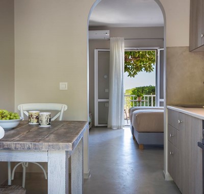 Kitchen, dining and views toward the sea through the French doors inside Beachfront Suite No2, Lourdata, Kefalonia