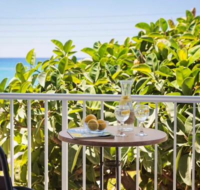Drinks in the treetops on the balcony with sea views from Beachfront Suite No3, Lourdata, Kefalonia