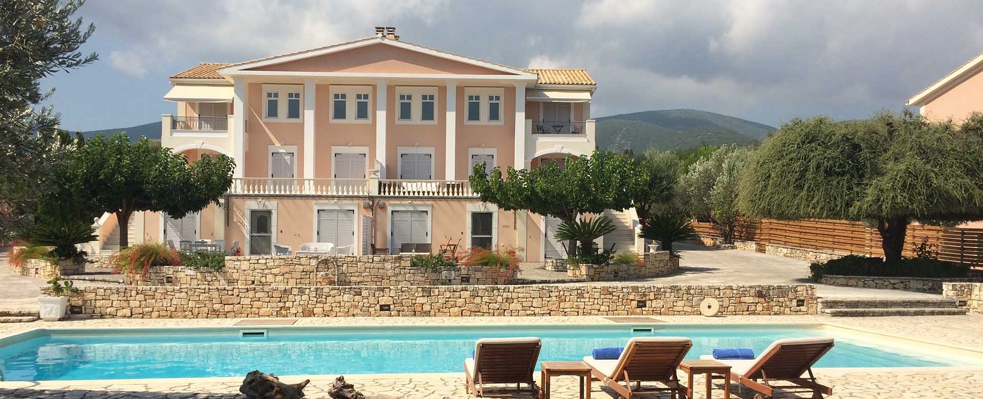 Outside view of Melissani Apartments including the pool and mountains of Kefalonia, Greek Islands