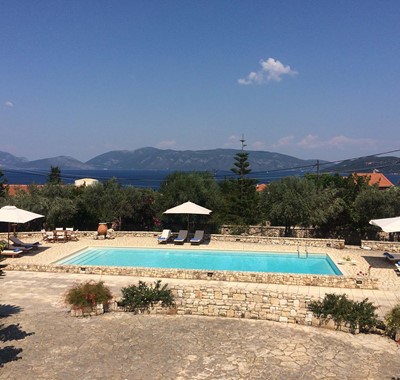 Pool Sun loungers sea and mountain views at Casa Angela, Melissani Apartments, Karavomilos, Kefalonia, Greek Islands
