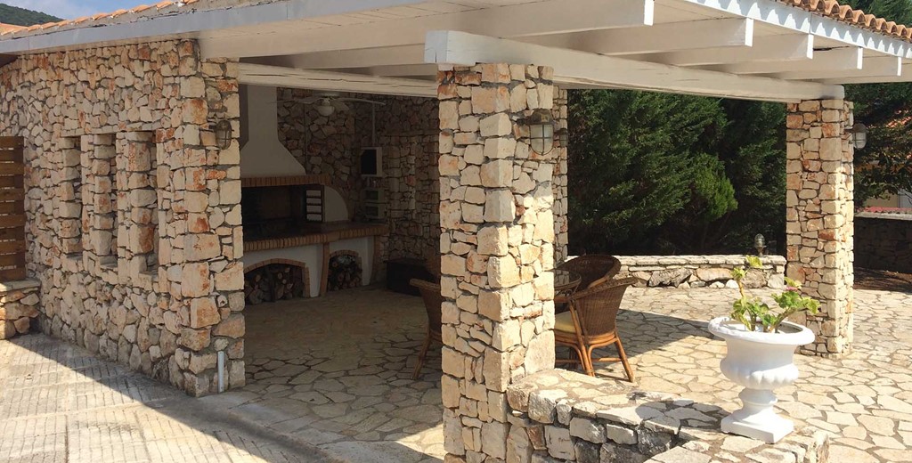 Pizza oven and shaded outside dining at Melissani Apartments, Karavomilos, Kefalonia, Greek Islands