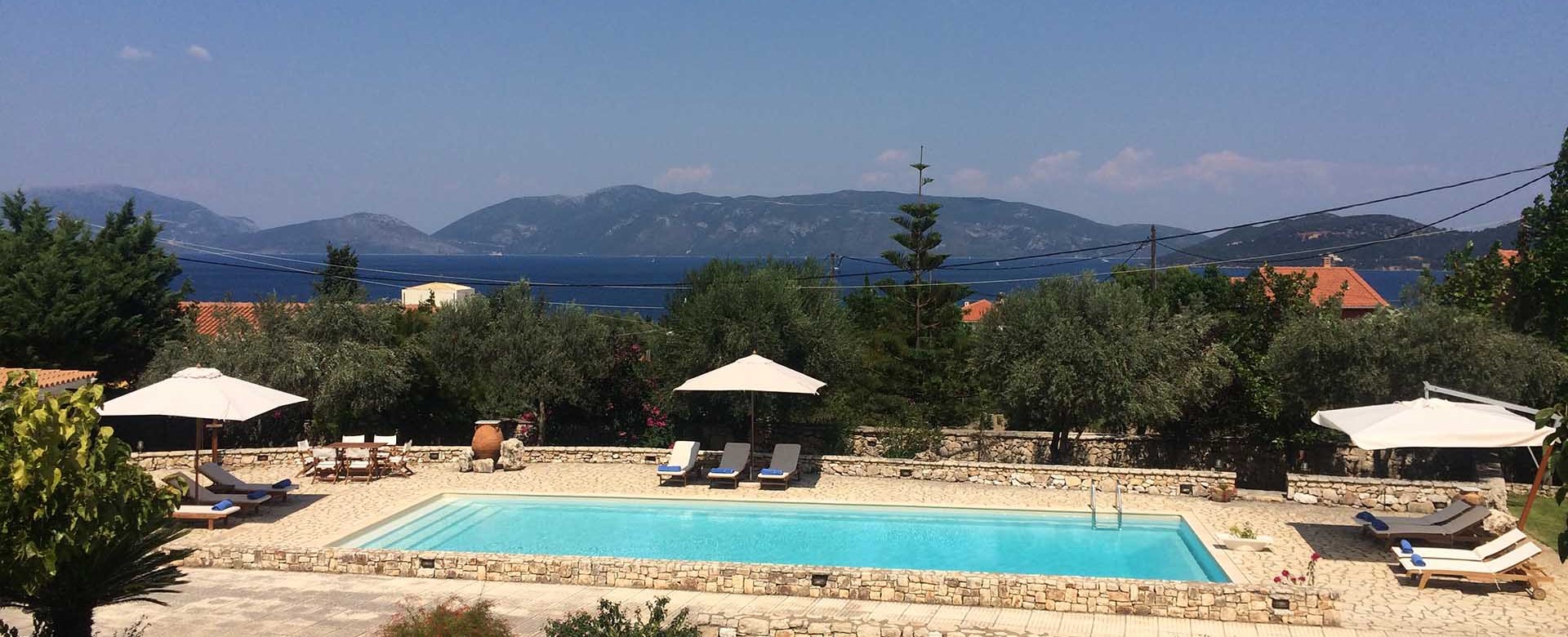 The pool, sea and mountain coastline make a great setting for a holiday in Melissani Apartments, Karavomilos, Kefalonia, Greek Islands