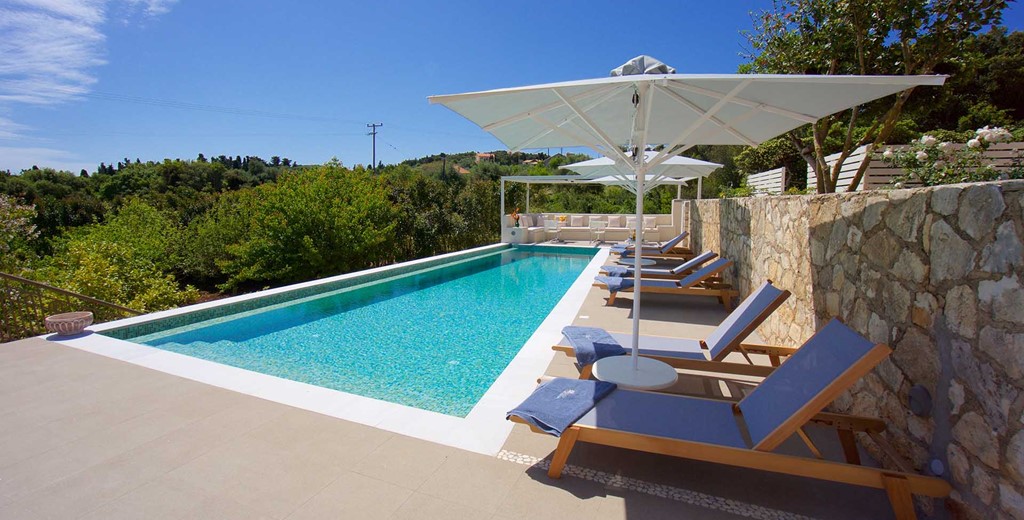 Pool sun beds and green views from Magnolia Apartments, Fiscardo, Kefalonia, Greek Islands