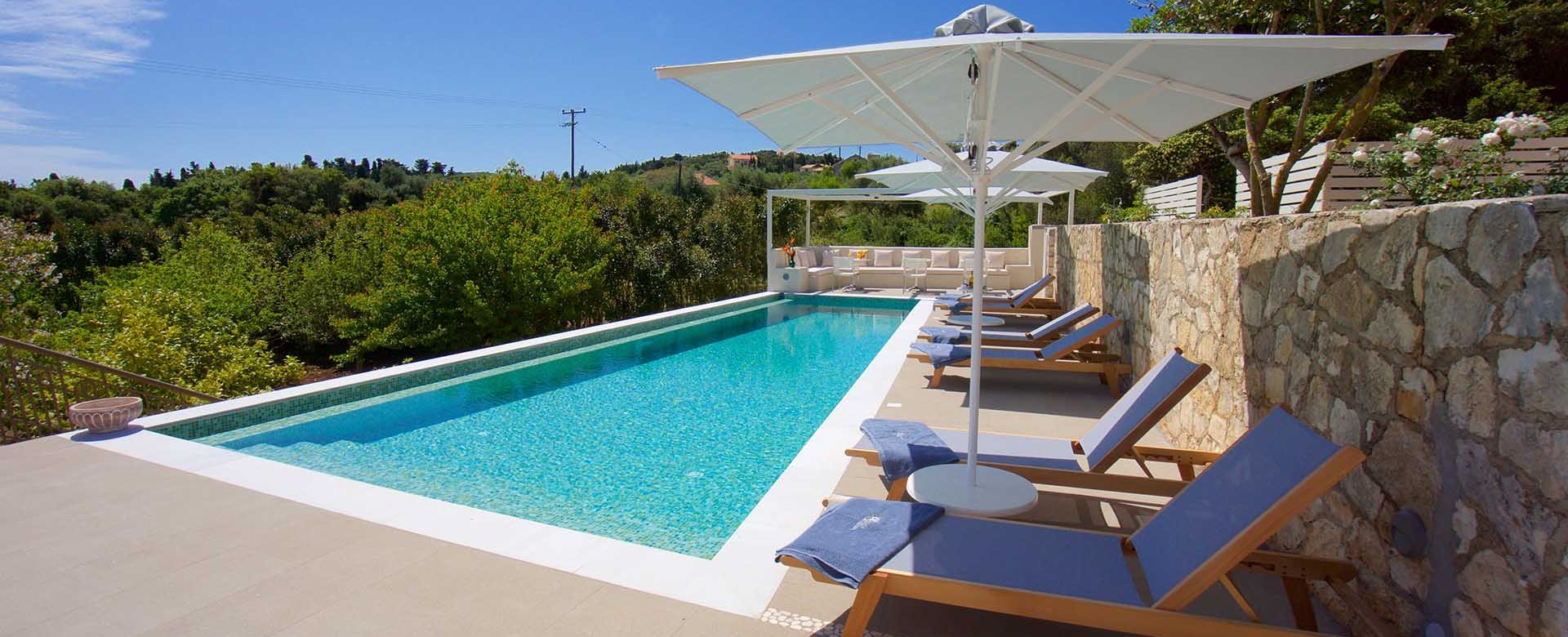 Pool sun beds and green views from Magnolia Apartments, Fiscardo, Kefalonia, Greek Islands