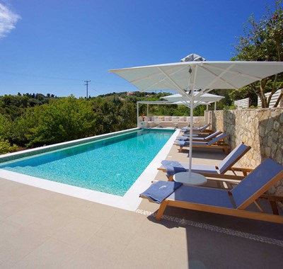 Pool sun beds and green views from Magnolia Apartments, Fiscardo, Kefalonia, Greek Islands