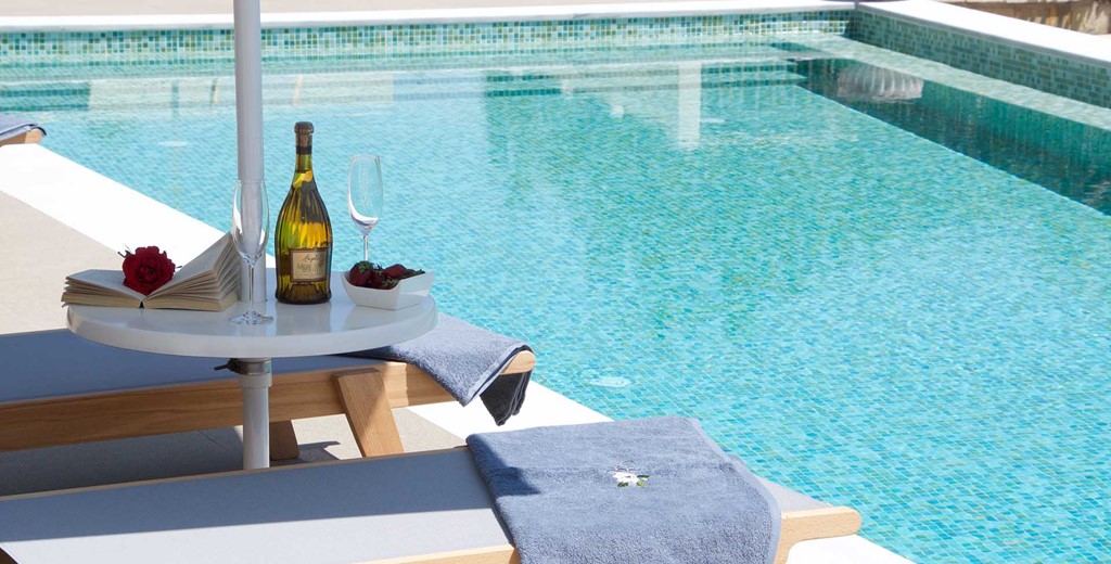 Reading and wine by the pool makes a relaxing holiday in Magnolia Apartments, Fiscardo, Kefalonia, Greek Islands