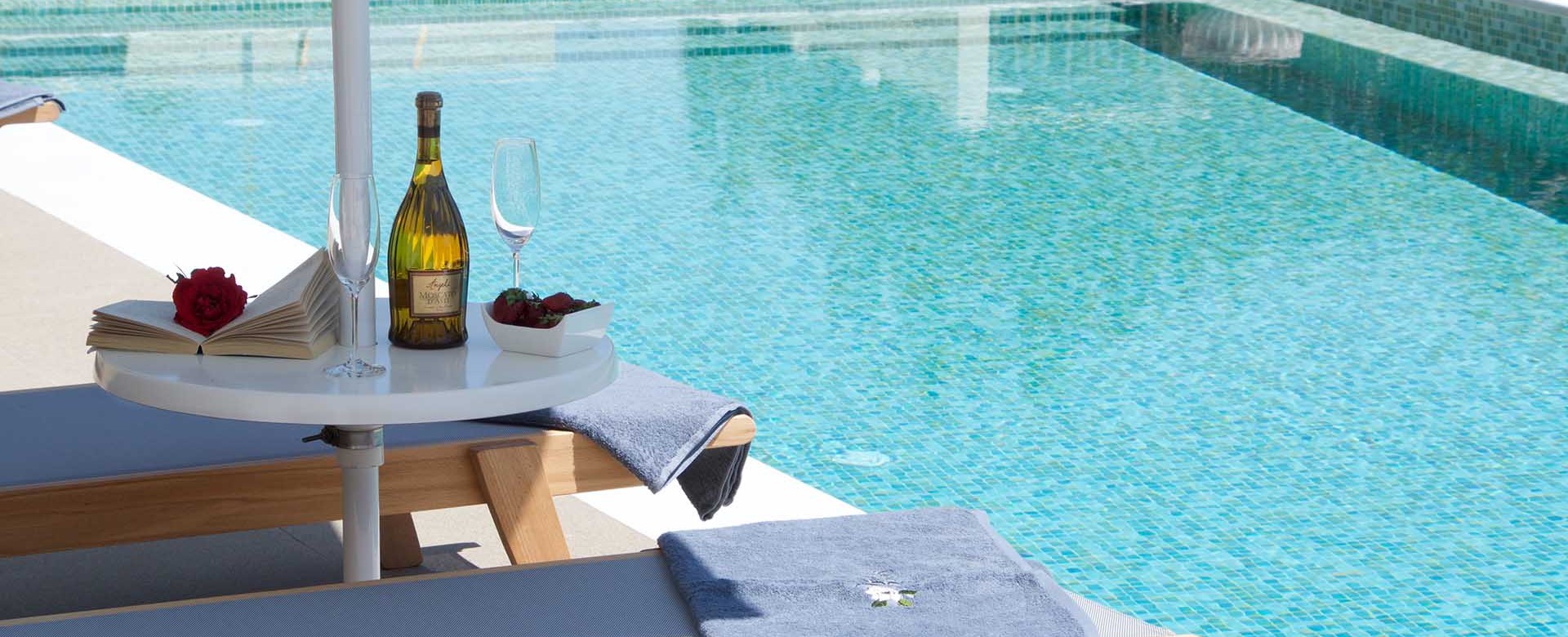 Reading and wine by the pool makes a relaxing holiday in Magnolia Apartments, Fiscardo, Kefalonia, Greek Islands