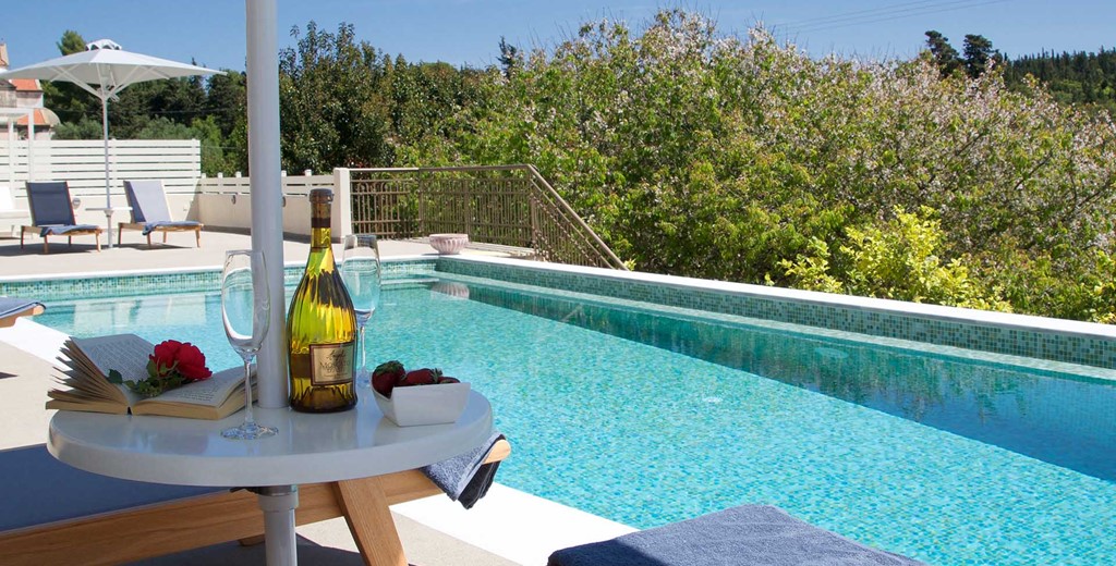 Get maximum holiday relaxation with a good book and good wine by the pool at Magnolia Apartments, Fiscardo, Kefalonia, Greek Islands
