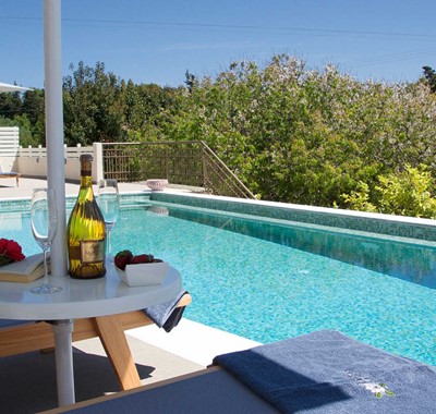 Get maximum holiday relaxation with a good book and good wine by the pool at Magnolia Apartments, Fiscardo, Kefalonia, Greek Islands