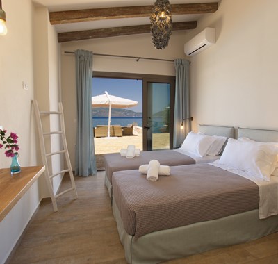 Bedroom with a view, twin beds and wide opening doors inside Villa Frydi, Karavomilos, Kefalonia, Greek Islands