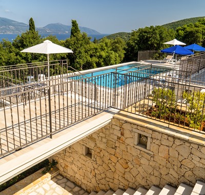 View across bridge to large private pool at Villa Gionis Fiscardo, Kefalonia, Greek Islands