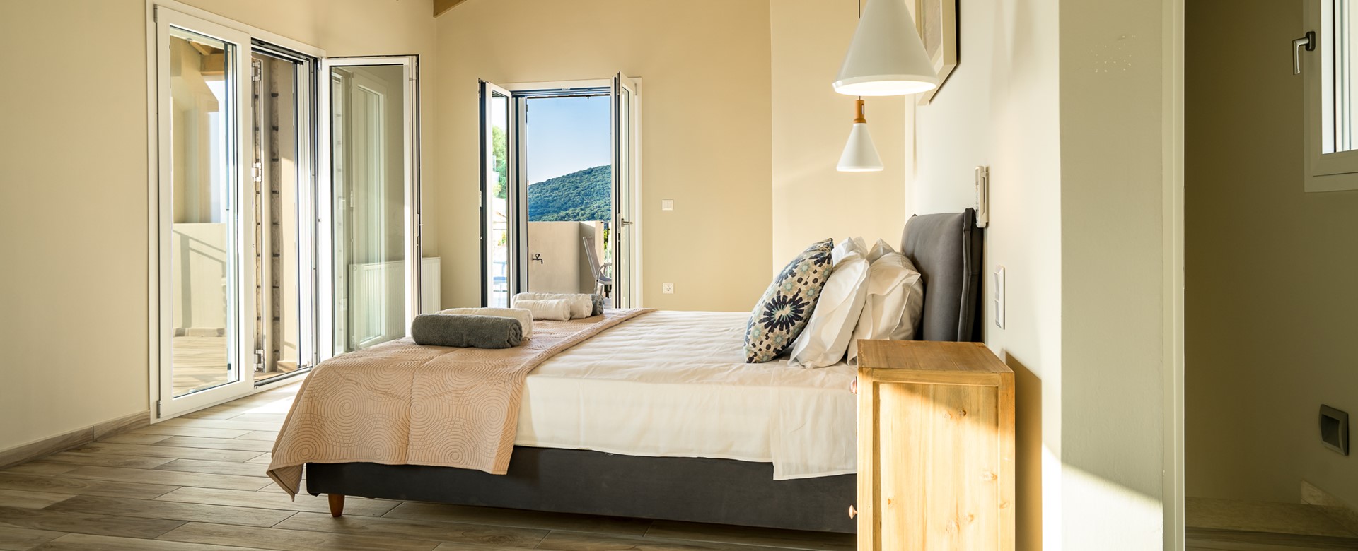 Wake up to double aspect views in a light and airy bedroom at Villa Gionis Fiscardo, Kefalonia, Greek Islands