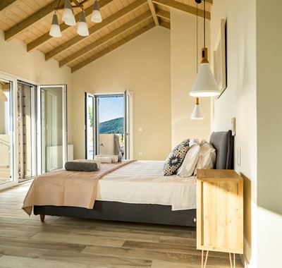 Wake up to double aspect views in a light and airy bedroom at Villa Gionis Fiscardo, Kefalonia, Greek Islands