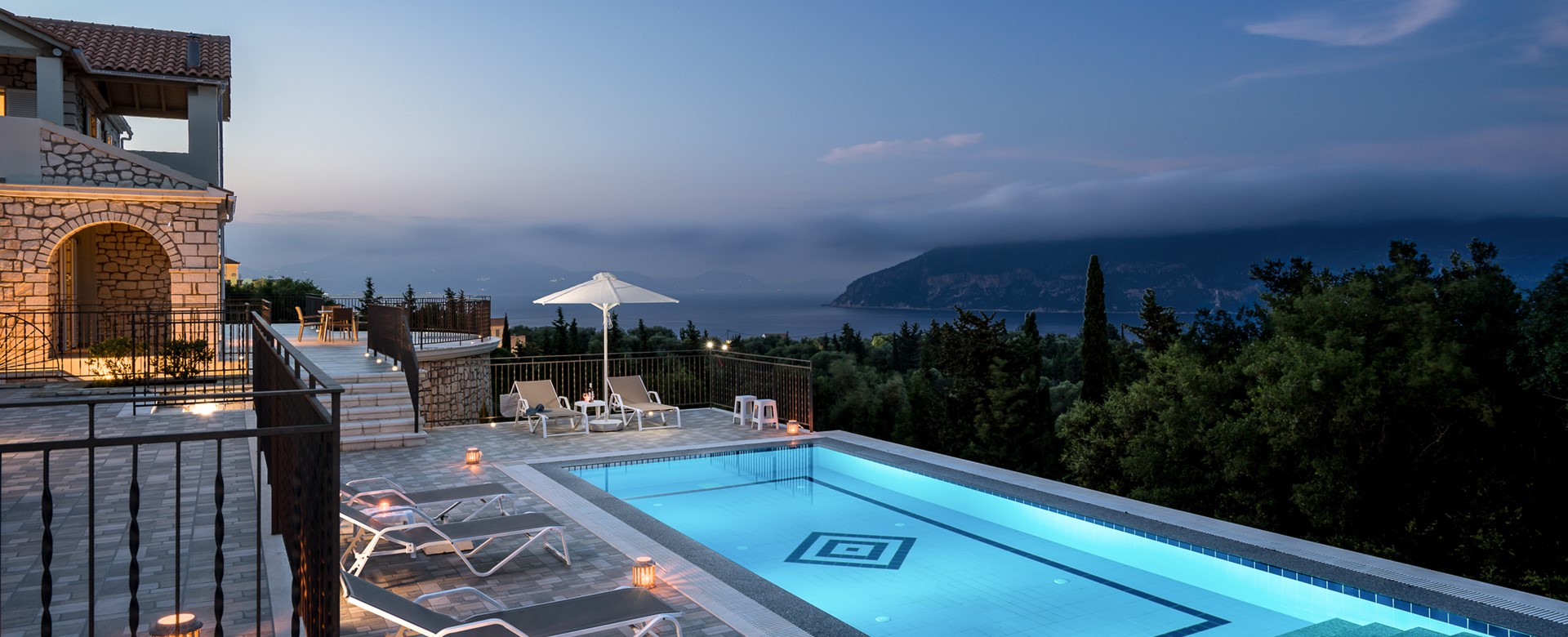 Stunning night time views across private pool to mountains at Villa Gionis Fiscardo, Kefalonia, Greek Islands