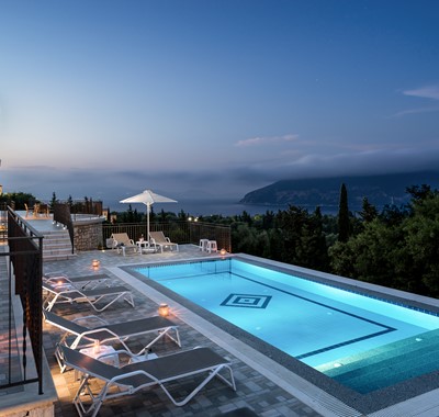 Stunning night time views across private pool to mountains at Villa Gionis Fiscardo, Kefalonia, Greek Islands