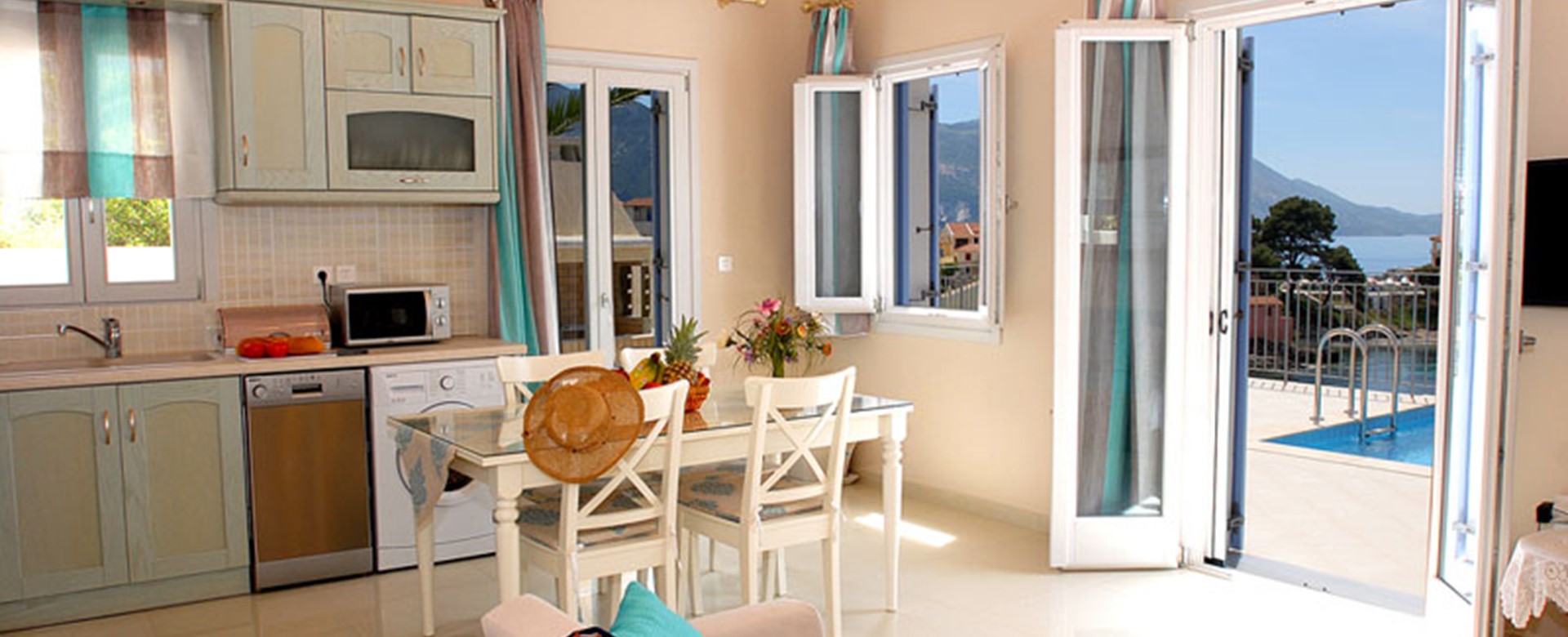 Dining and kitchen with French doors and view out into the bay, Villa Panorama, Assos, Kefalonia