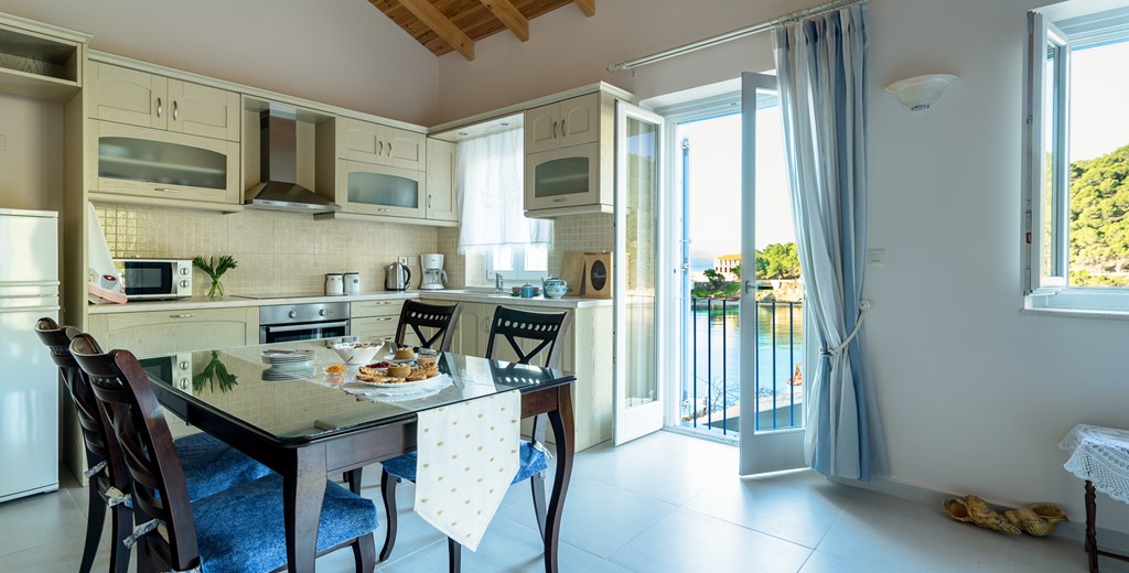 Full equipped kitchen diner with French doors to terrace at Villa Petrino, Assos, Kefalonia, Greek Islands