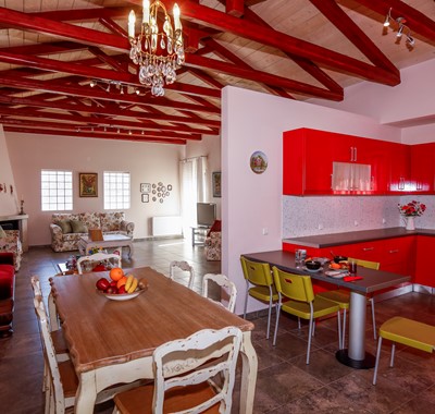 Large vaulted open plan dining area with an eclectic mix of modern and antique furniture at Rosie's Herb Cottage, Assos, Kefalonia, Greek Islands