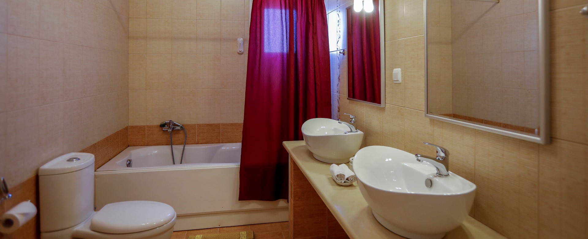 Bathroom with shower over bath and 'his & hers' sinks at Rosie's Herb Cottage, Assos, Kefalonia, Greek Islands
