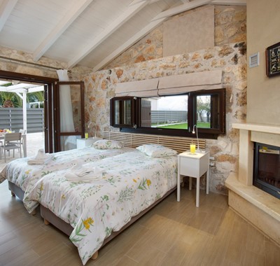 Exceptionally decorated twin room with bifold door access to outside terrace at Villa Theano, Sami, Kefalonia, Greek Islands