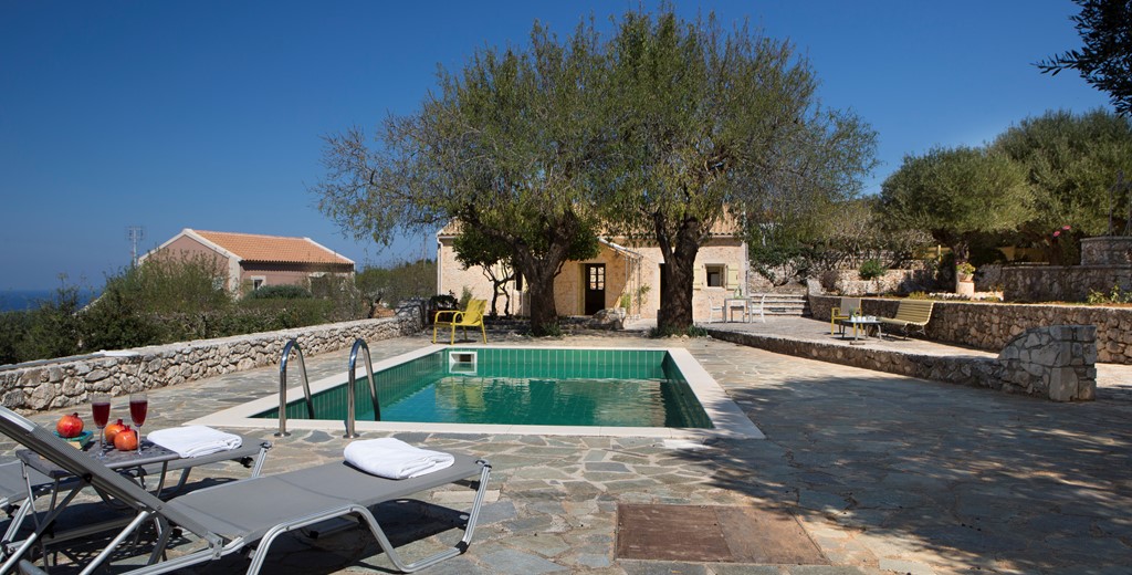 Pool, sun loungers and trees make a great escape outside Lemoni Cottage, Fiscardo, Kefalonia