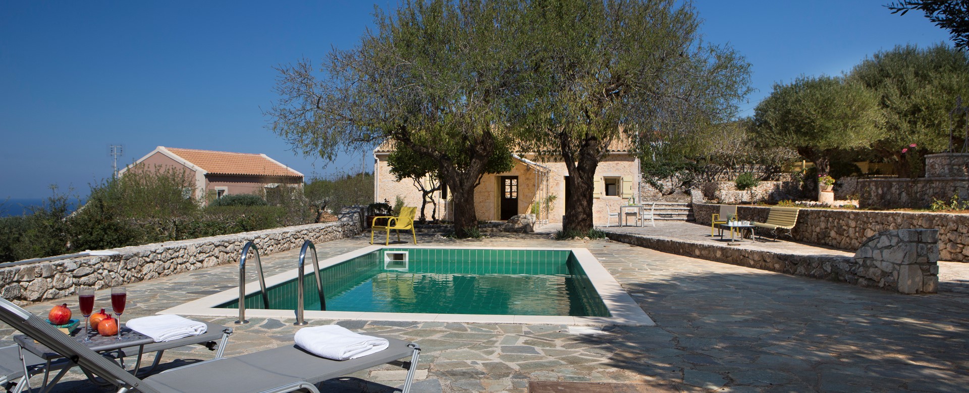 Pool, sun loungers and trees make a great escape outside Lemoni Cottage, Fiscardo, Kefalonia