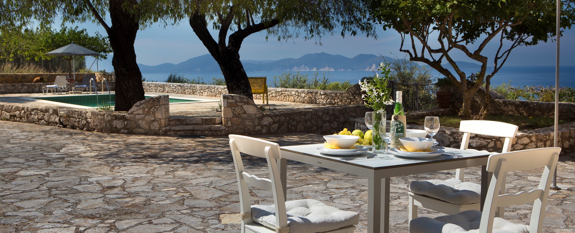 Light lunch in the sun with sea views outside Lemoni Cottage, Fiscardo, Kefalonia
