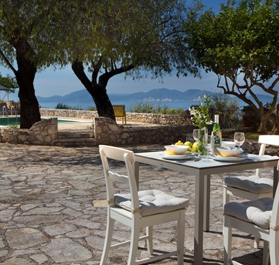 Light lunch in the sun with sea views outside Lemoni Cottage, Fiscardo, Kefalonia