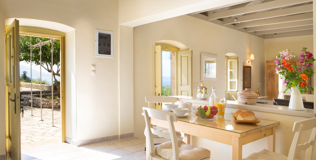 Dining with the doors open to let the view in at Lemoni Cottage, Fiscardo, Kefalonia