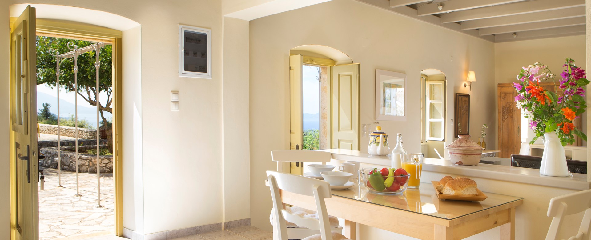 Dining with the doors open to let the view in at Lemoni Cottage, Fiscardo, Kefalonia