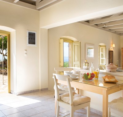Dining with the doors open to let the view in at Lemoni Cottage, Fiscardo, Kefalonia