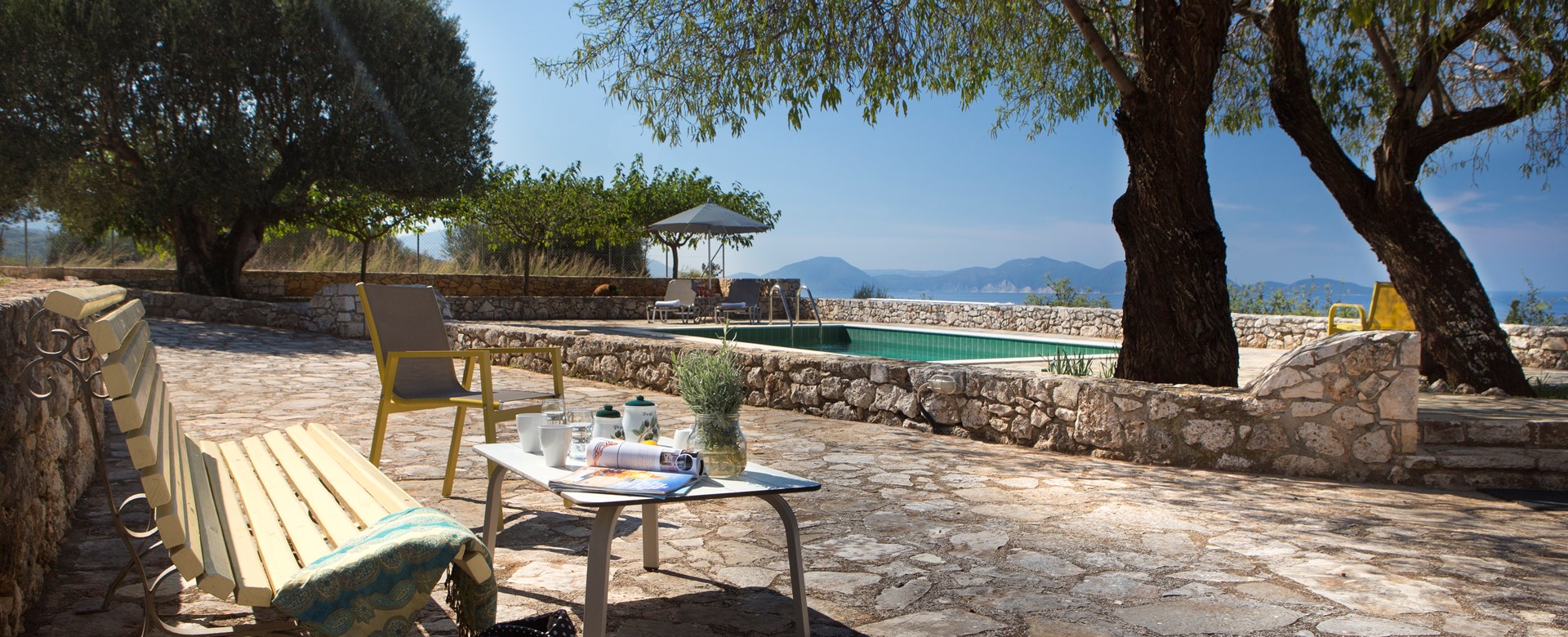 Bench to relax on during the afternoon sun with trees for shade outside Lemoni Cottage, Fiscardo, Kefalonia