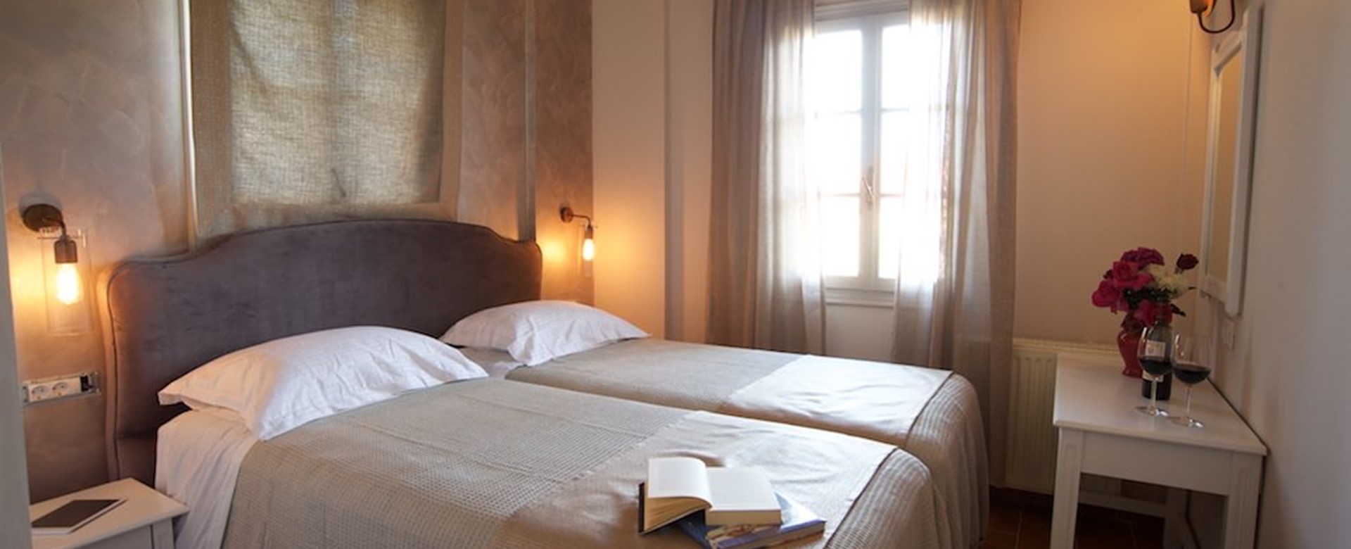 Large beds and subtle lighting inside Magnolia Apartments, Fiscardo, Kefalonia, Greek Islands