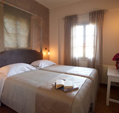 Large beds and subtle lighting inside Magnolia Apartments, Fiscardo, Kefalonia, Greek Islands