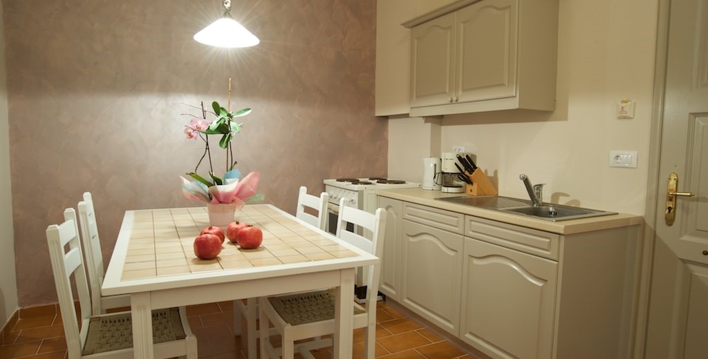 Galley kitchen and dining space inside Magnolia Apartments, Fiscardo, Kefalonia, Greek Islands