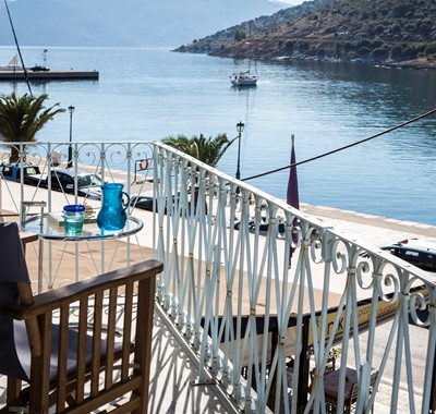 Watch the yachts and boats go out to sea in the morning while enjoying a morning coffee on the balcony of Palm House Harbourfront Mansion, Agia Efimia, Kefalonia, Greek Islands
