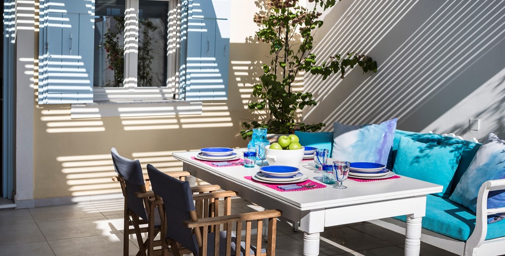 Family breakfast and dinner together during your holiday in the shaded private area of Palm House Harbourfront Mansion, Agia Efimia, Kefalonia, Greek Islands